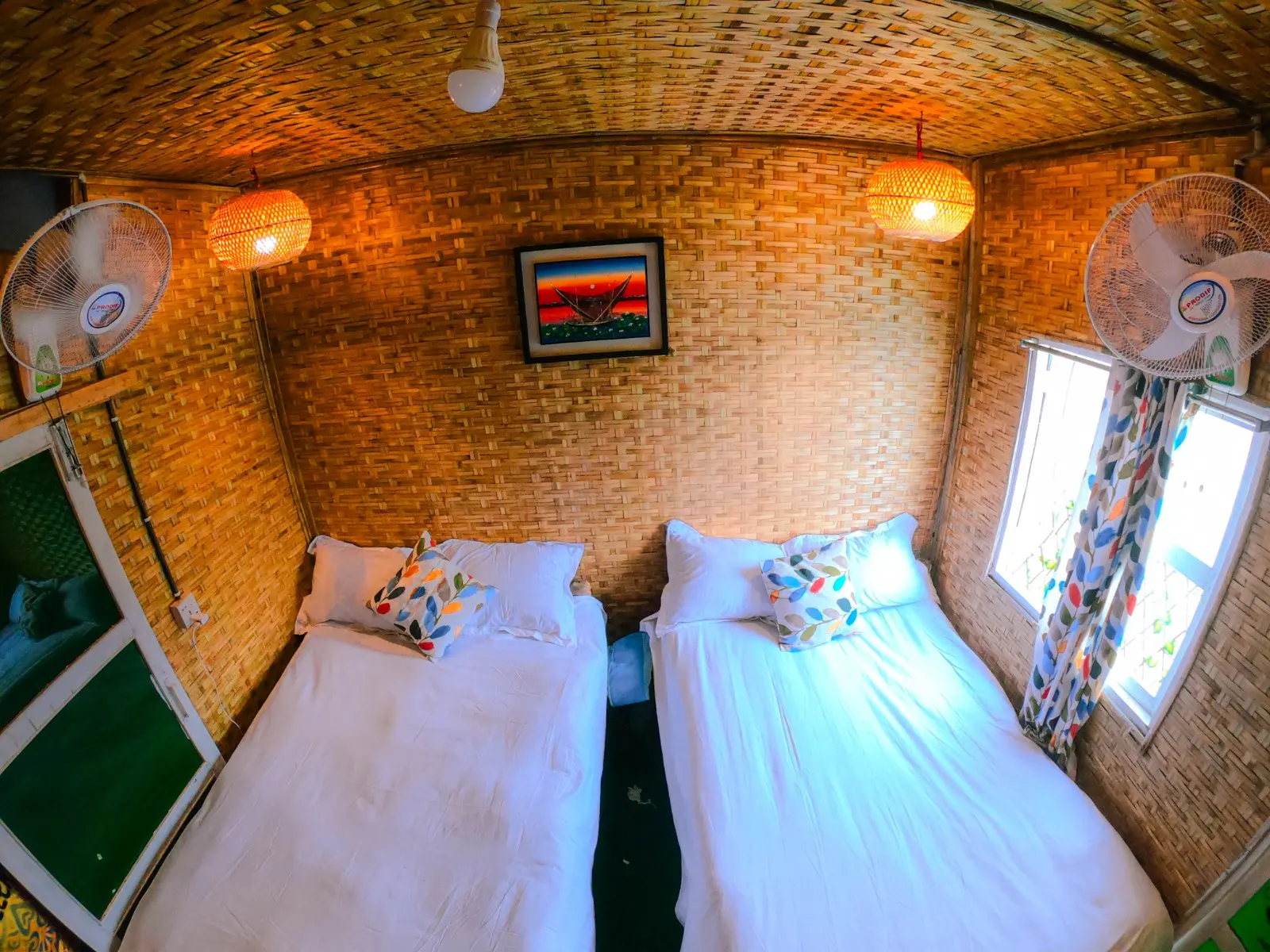 Inside a Tanguar Haor houseboat cabin with twin beds